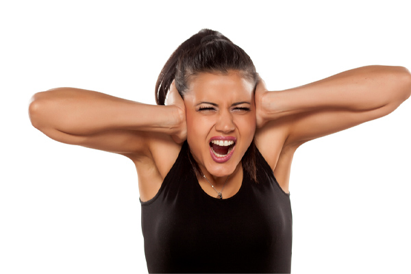 image of a woman covering her ears due to oil furnace noise