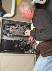 furnace repairman working on a residential heating system
