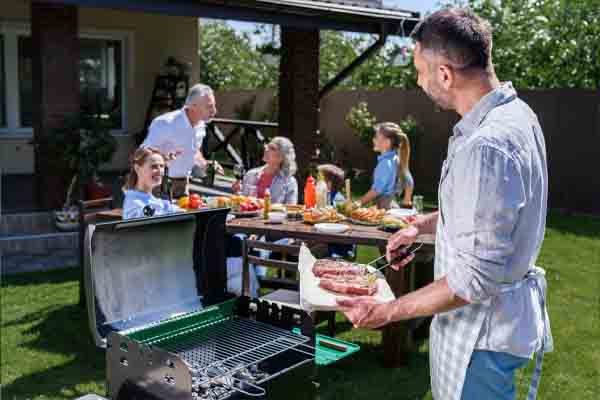 Happy family at barbecue to save on cooling costs