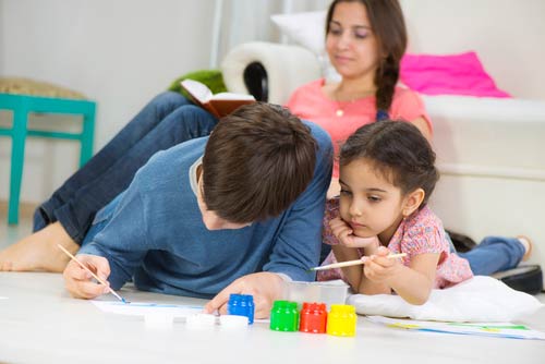 Kids playing at home in room cooled with central AC