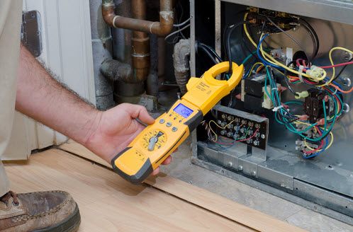 picture of furnace repairman fixing a heater in lehighton