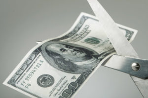 image of scissors cutting bill depicting saving money with heating oil delivery