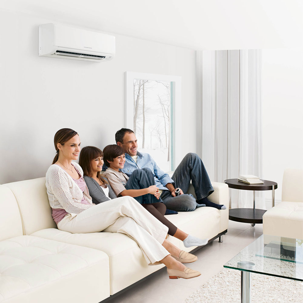 Family on Couch enjoying comfort solutions with ductless