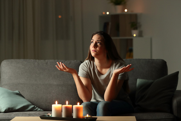 woman during power outage and malfunctioning backup generator