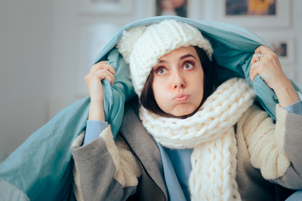 image of a homeowner feeling chilly due to hvac emergency