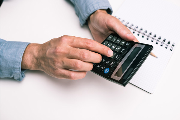 image of hand and calculator depicting home cooling costs