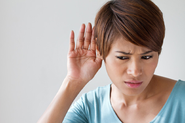 image of a homeowner holding ear and listening to whistle from heating oil delivery