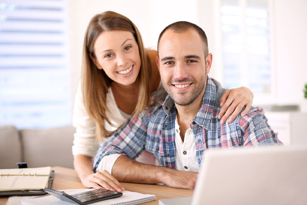 Smiling couple calculating home heating savings