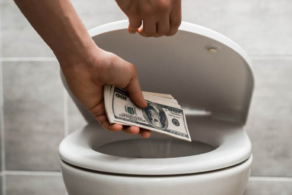 image of a homeowner flushing money down the toilet depicting water costs and running toilet