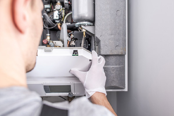 image of an hvac contractor repairing a furnace with a leak