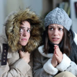 image of a homeowner feeling chilly due to thermostat problems