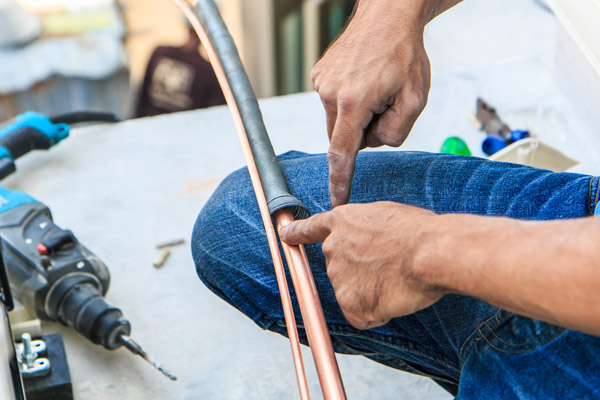 image of an hvac contractor performing an air conditioner installation