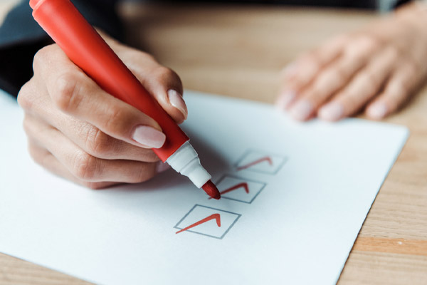 image of homeowner making checklist depicting what to look for hvac maintenance agreement