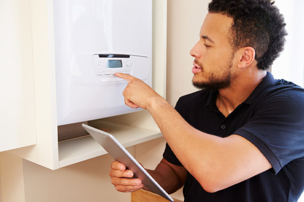 image of a homeowner adjusting boiler temperature