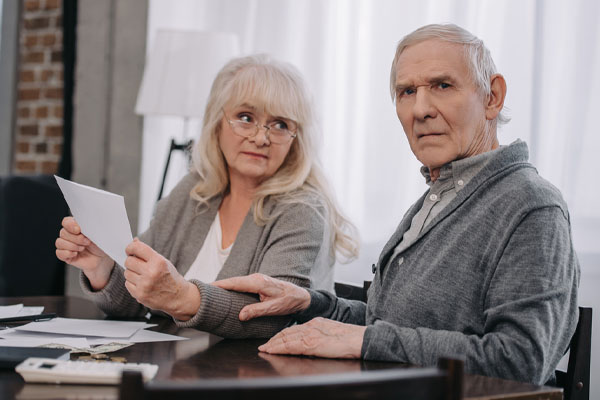image of an elderly couple worried about home energy bills due to air drafts in home